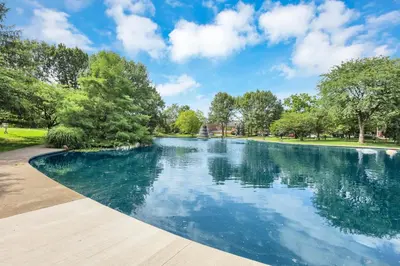 a swimming pool in a park with trees at The Nook on Neil Walkable 3BR in Columbus