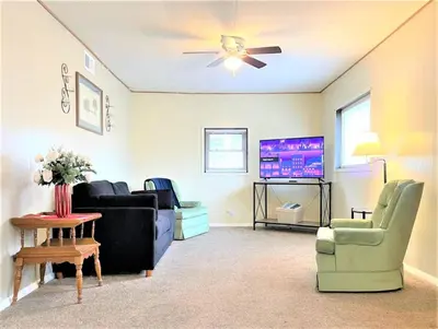 a living room with couches and a flat screen tv at High - Family Neighborhood, Pet Friendly in Van Wert