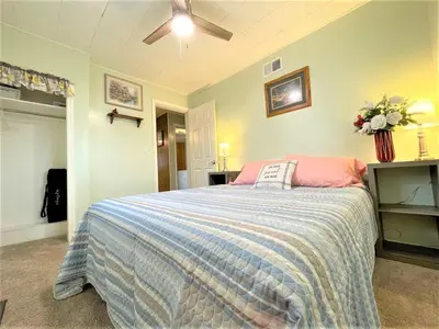 a bedroom with a bed with a blue and pink blanket at High - Family Neighborhood, Pet Friendly in Van Wert