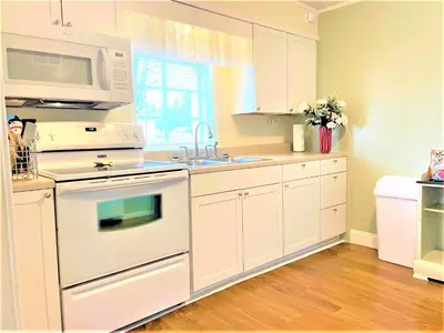 a kitchen with white appliances and a microwave at High - Family Neighborhood, Pet Friendly in Van Wert
