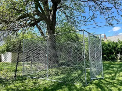 a chain link fence in front of a tree at Pontiac - Secluded Backyard, Pet Friendly in Fort Wayne