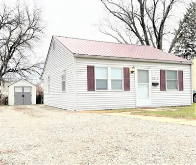 a white house with a red roof and a driveway at Pontiac - Secluded Backyard, Pet Friendly in Fort Wayne