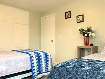 a bedroom with two beds and a vase of flowers at North - Family Neighborhood, Pet Friendly in Paulding