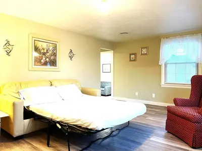 a bedroom with a bed and a couch at North - Family Neighborhood, Pet Friendly in Paulding