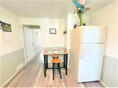 a small kitchen with a table and a refrigerator at North - Family Neighborhood, Pet Friendly in Paulding