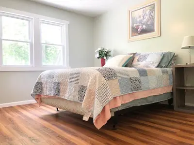 a bedroom with a bed with a blanket on it at Rabus GIANT Yard and Parking Nature Shopping in Fort Wayne