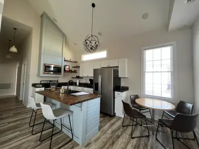 a kitchen with a counter and a table and chairs at B St Bungalow in Gas City
