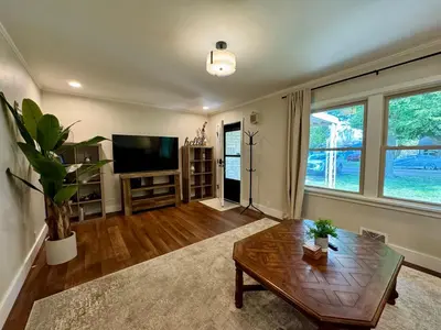 a living room with a table and a tv at Campus Den on Poplar St in Marion