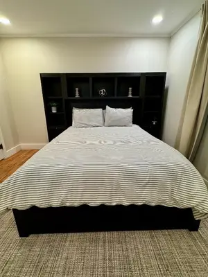 a bedroom with a large bed with a striped blanket at Campus Den on Poplar St in Marion