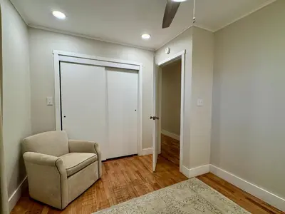 a living room with a chair and a door at Campus Den on Poplar St in Marion