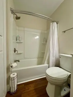 a bathroom with a toilet and a tub and a shower at Campus Den on Poplar St in Marion