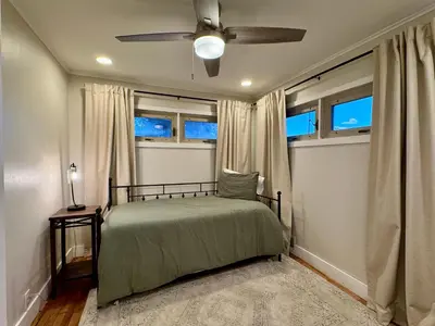 a bedroom with a bed and a ceiling fan at Campus Den on Poplar St in Marion