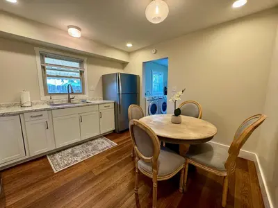 a kitchen with a table and a refrigerator at Campus Den on Poplar St in Marion