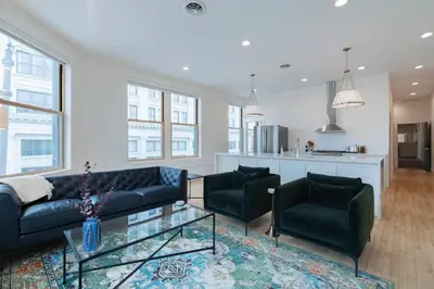 a living room with a couch and two chairs and a table at 'Condo A' Gallery Suite - Downtown Marion in Warren