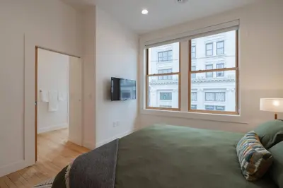 a bedroom with a large bed and a window at 'Condo A' Gallery Suite - Downtown Marion in Warren