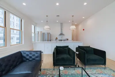 a living room with a couch and two chairs at 'Condo A' Gallery Suite - Downtown Marion in Warren