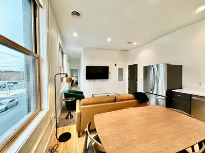 a living room with a couch and a table at Condo B - Gallery Suite - Downtown Marion in Warren