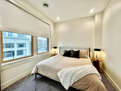 a bedroom with a bed and a large window at Condo B - Gallery Suite - Downtown Marion in Warren