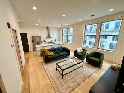 a living room with a couch and two chairs at Condo C - Gallery Suites Downtown Marion in Warren