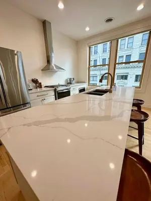 a kitchen with a large white counter top at Condo C - Gallery Suites Downtown Marion in Warren