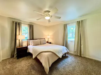 a bedroom with a bed with a ceiling fan at Idle Springs in Marion