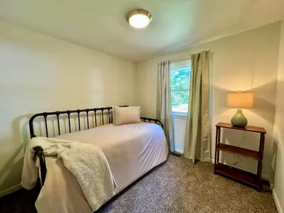 a bedroom with a bed with a lamp and a window at Idle Springs in Marion