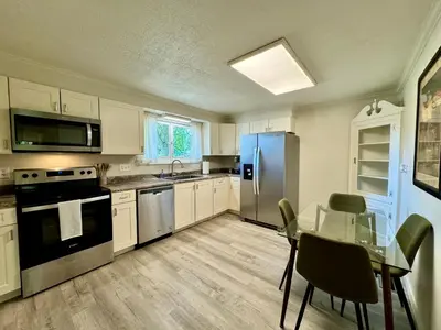 a kitchen with a table and a blue refrigerator at Idle Springs in Marion
