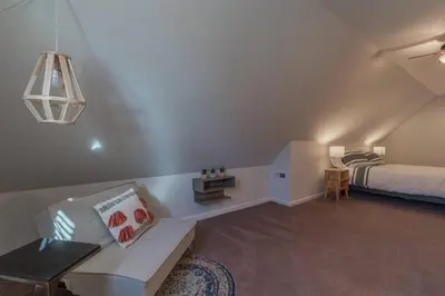 a living room with a bed and a couch at Loft on Landess in Marion