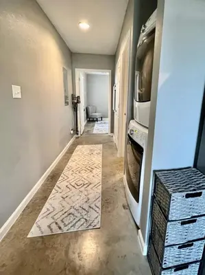 a hallway with a laundry room with a washing machine at Posh Pad in Marion