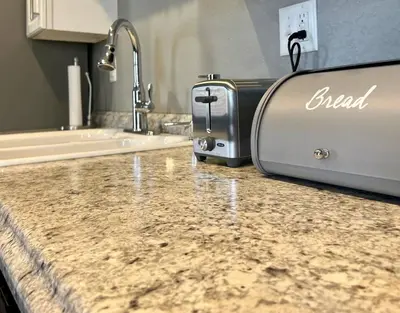 a kitchen counter with a toaster sitting on top of it at Posh Pad in Marion