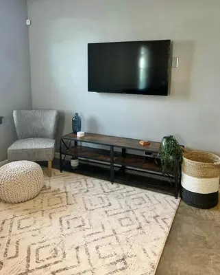 a living room with a flat screen tv on the wall at Posh Pad in Marion