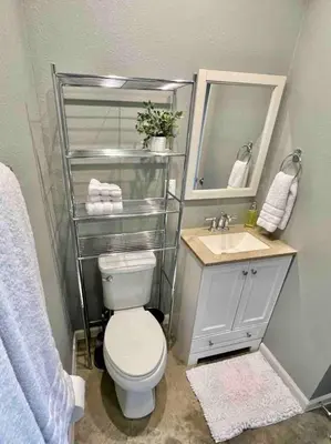 a bathroom with a toilet and a sink and a mirror at Posh Pad in Marion