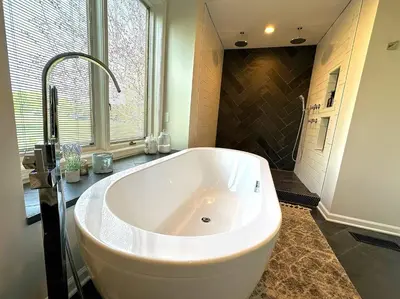 a large white tub in a bathroom with a window at Four Oaks Ranch in Marion
