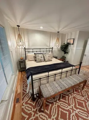 a bedroom with a bed and a bench in it at Four Oaks Ranch in Marion