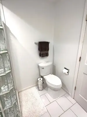 a bathroom with a toilet and a towel on the wall at Four Oaks Ranch in Marion
