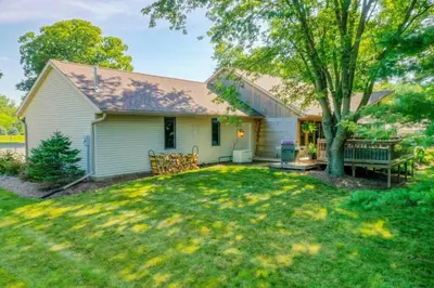 a small white house with a tree in the yard at Four Oaks Ranch in Marion