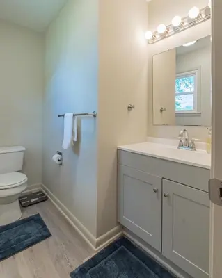 a bathroom with a sink and a toilet and a mirror at The Lime House in Gas City