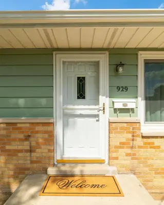 a door with a welcome sign in front of a house at The Lime House in Gas City