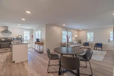 a kitchen and living room with a table and chairs at The Luxe in Marion