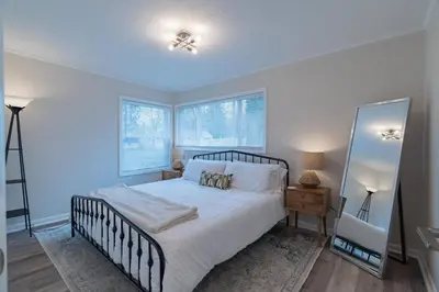 a bedroom with a large bed and a mirror at Tin Roof Inn in Marion