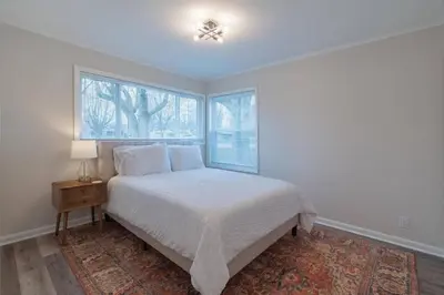a white bedroom with a bed and a window at Tin Roof Inn in Marion