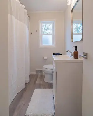 a white bathroom with a sink and a toilet at Tin Roof Inn in Marion