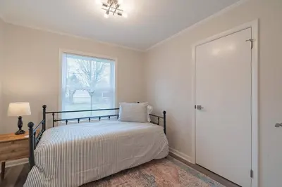 a bedroom with a bed and a window at Tin Roof Inn in Marion