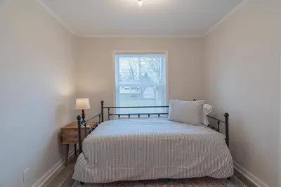 a bed in a room with a window at Tin Roof Inn in Marion