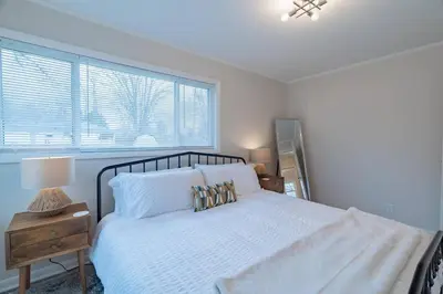 a bedroom with a white bed and a window at Tin Roof Inn in Marion