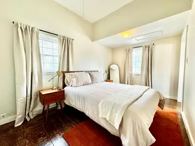 a bedroom with a large bed and windows at Trojan Hideaway on First Street in Gas City