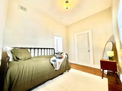 a bedroom with a bed and a table and a window at Trojan Hideaway on First Street in Gas City