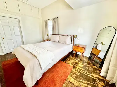 a bedroom with a large bed and a mirror at Trojan Hideaway on First Street in Gas City