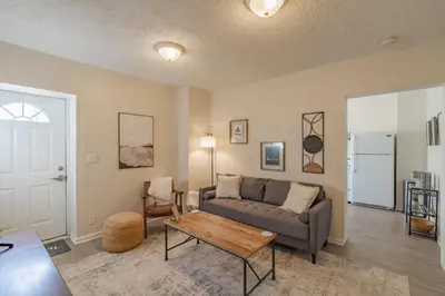 a living room with a couch and a table at University Suite 