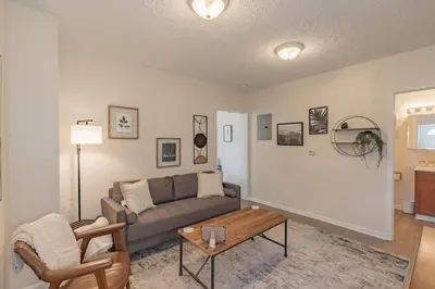 a living room with a couch and a coffee table at University Suite 